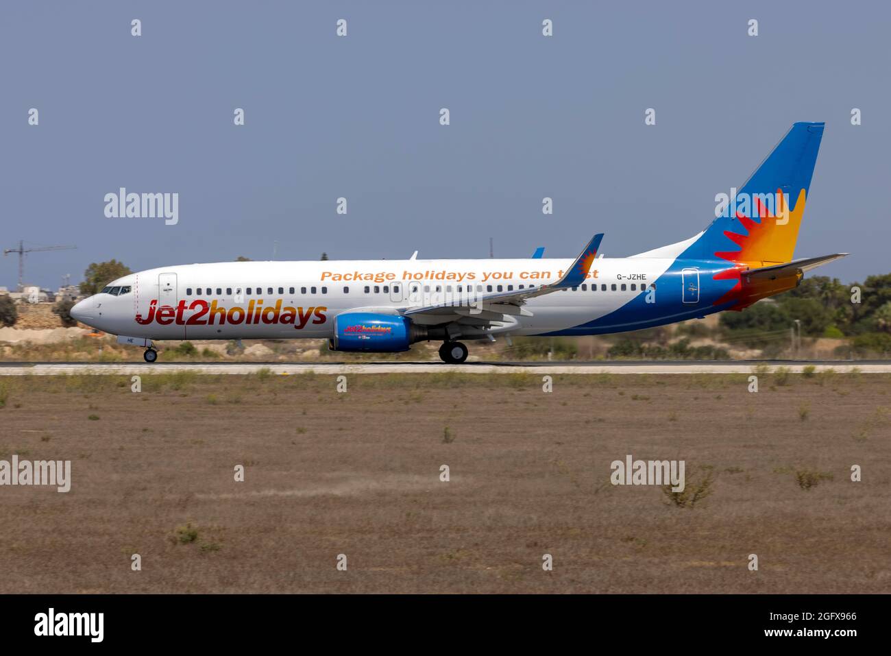 Boeing 737-8K5 (Reg.: G-JZHE) starting its take off run. Stock Photo