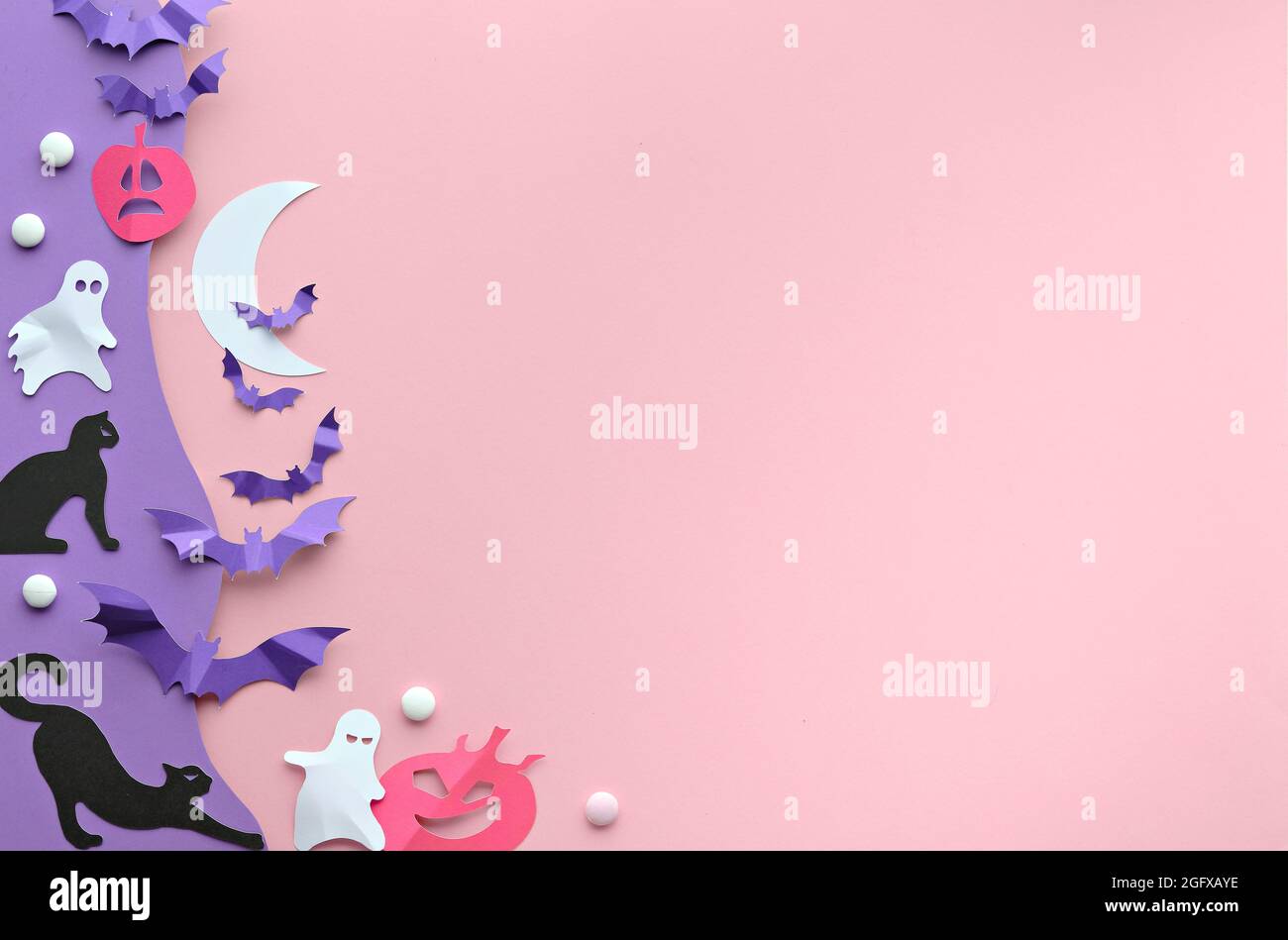 Cute Halloween background with kawaii black cats, vibrant purple paper bats, pink pumpkins, sugar sweets and funny white ghosts. Flat lay on pink and Stock Photo