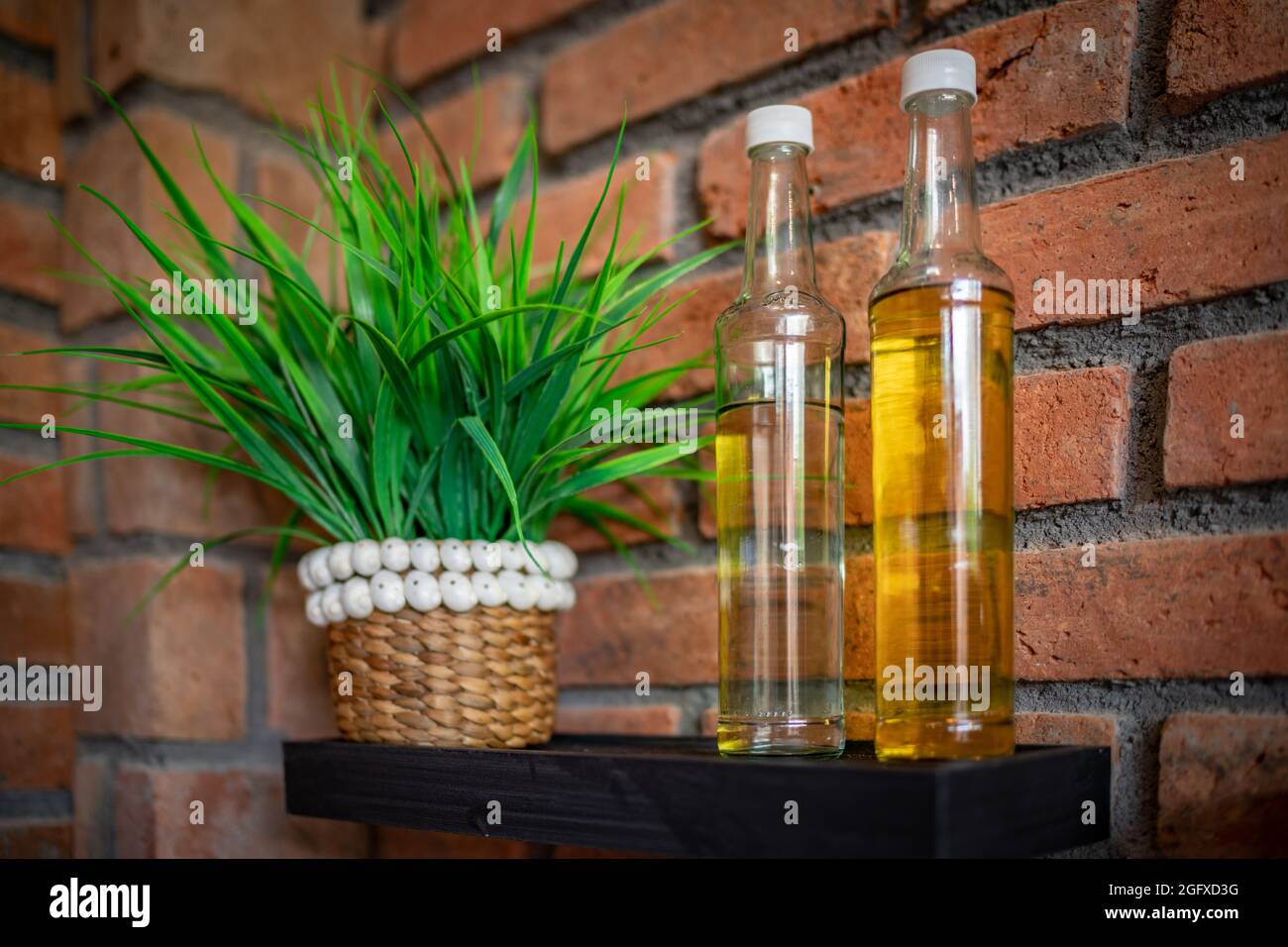 details kitchen interior. Bottles with oil, flowers, paintings on the wall. Stock Photo