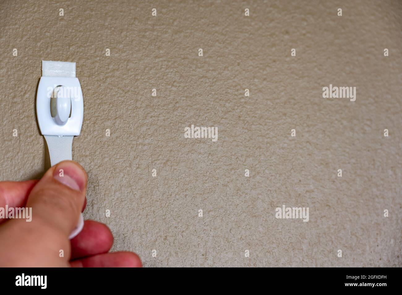 Selective focus on adhesive strip wall hanger that can be removed by