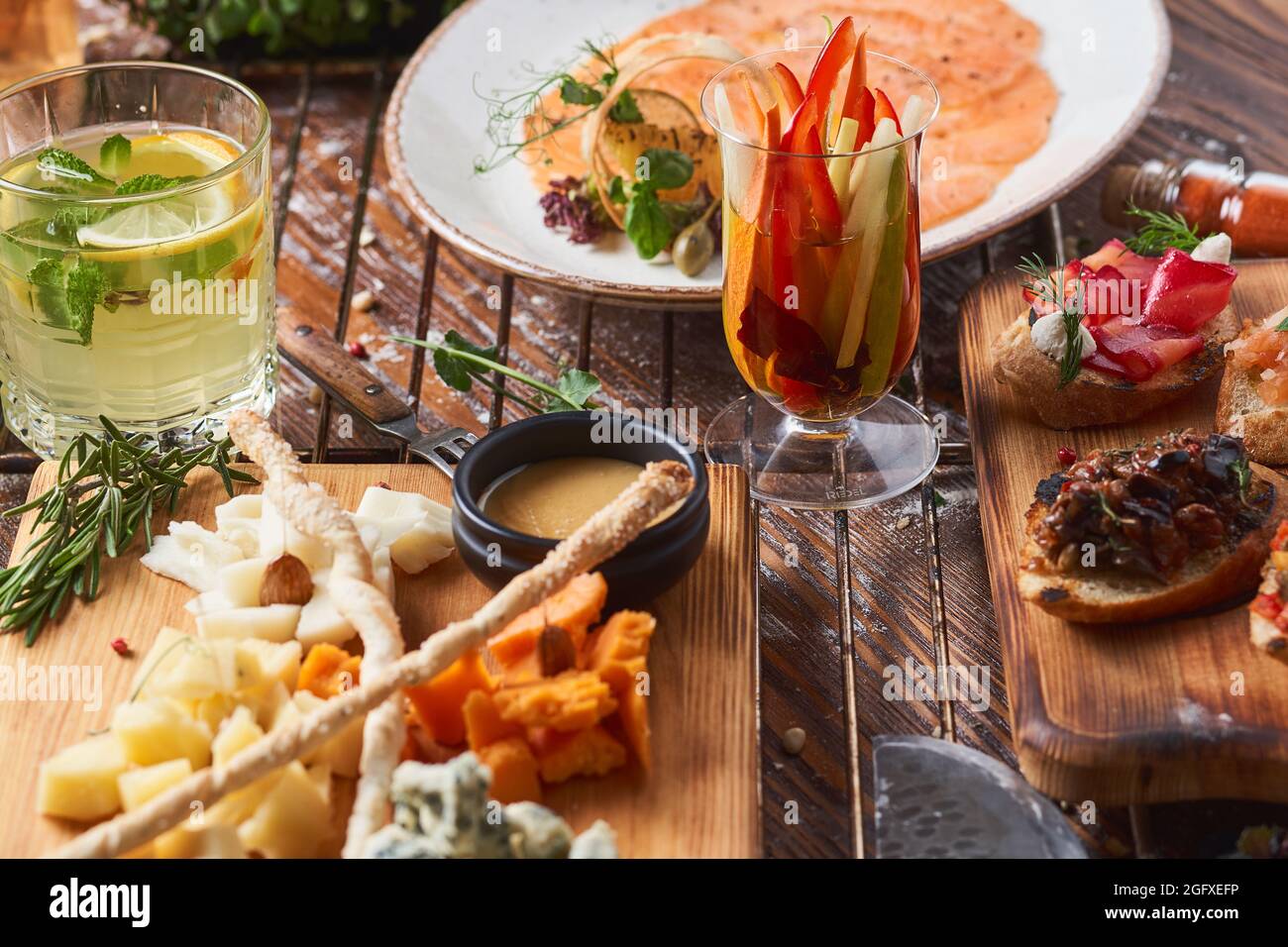 antipasti, different types of cheese on a wooden board with honey Stock