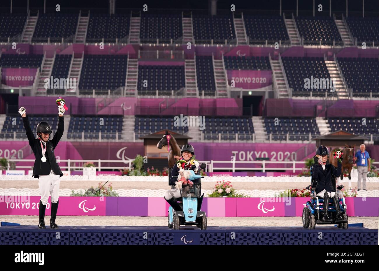 USA's Roxanne Trunnell (centre) poses with her gold medal after winning the Dressage Individual Test - Grade One alongside second placed Latvia's Rihards Snikus (left) with his silver medal and third placed Italy's Sara Morganti with her bronze medal at the Equestrian Park during day three of the Tokyo 2020 Paralympic Games in Japan. Picture date: Friday August 27, 2021. Stock Photo