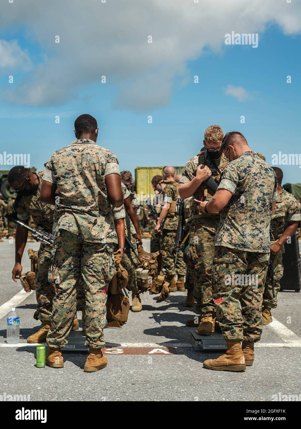 U.S. Marines with Combat Logistics Battalion 4, 3d Marine Logistics Group, and 2d Battalion, 3d Marines, 3d Marine Division, inspect gear weight during an integrated rapid response inspection at Kadena Air Base, Okinawa, Japan, August 25, 2021. Routine short-notice inspections ensure III MEF Marines remain ready to rapidly deploy and maintain regional security in the Indo-Pacific. 3d MLG, based out of Okinawa, Japan, is a forward deployed combat unit that serves as III Marine Expeditionary Force’s comprehensive logistics and combat service support backbone for operations throughout the Indo-Pa Stock Photo