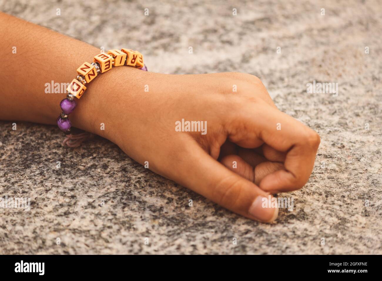 Young kid wearing a friendship band in wrist Stock Photo Alamy