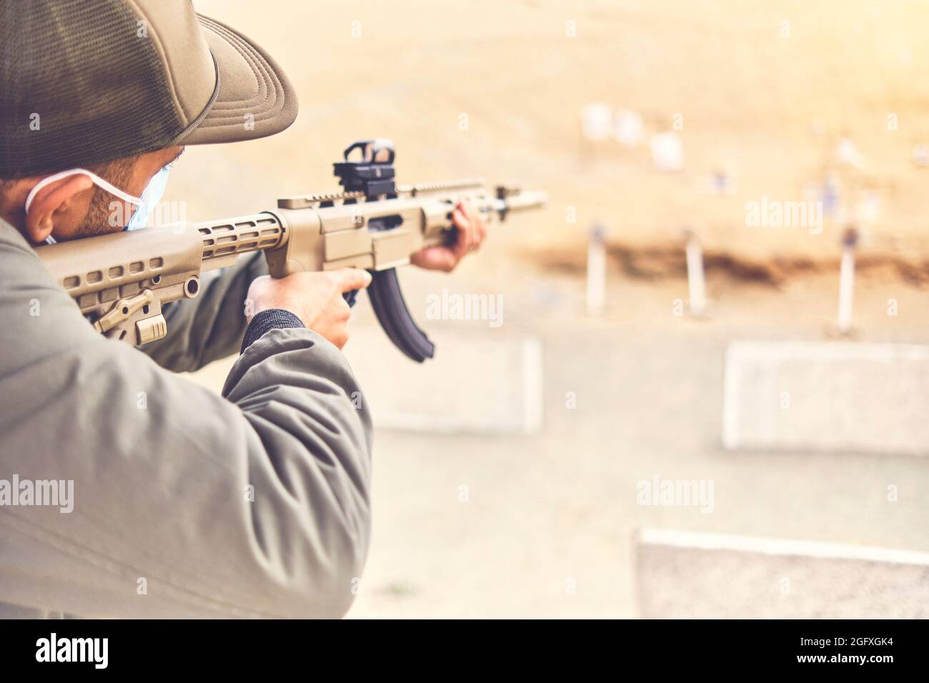Men practicing shooting with a assault rifle at target. Selective Focus Stock Photo