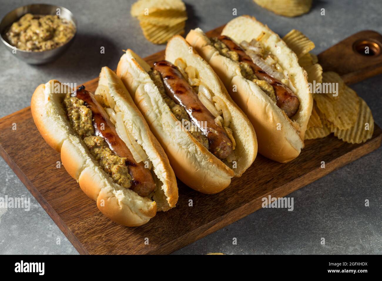 Homemade German Bratwurst Sandwich with Mustard and Onion Stock Photo