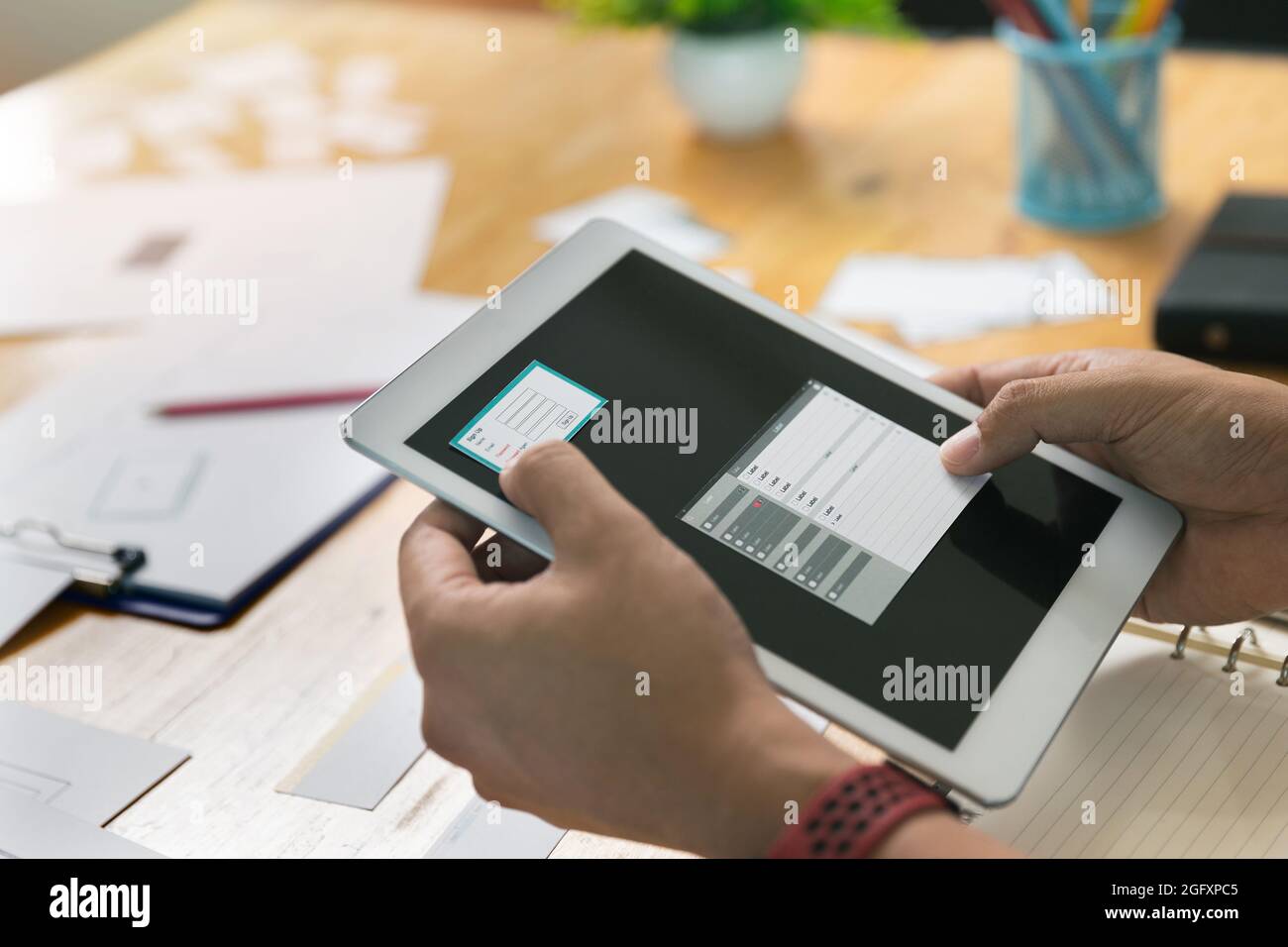 UX or UI designers designing on digital tablet and smartphone ...