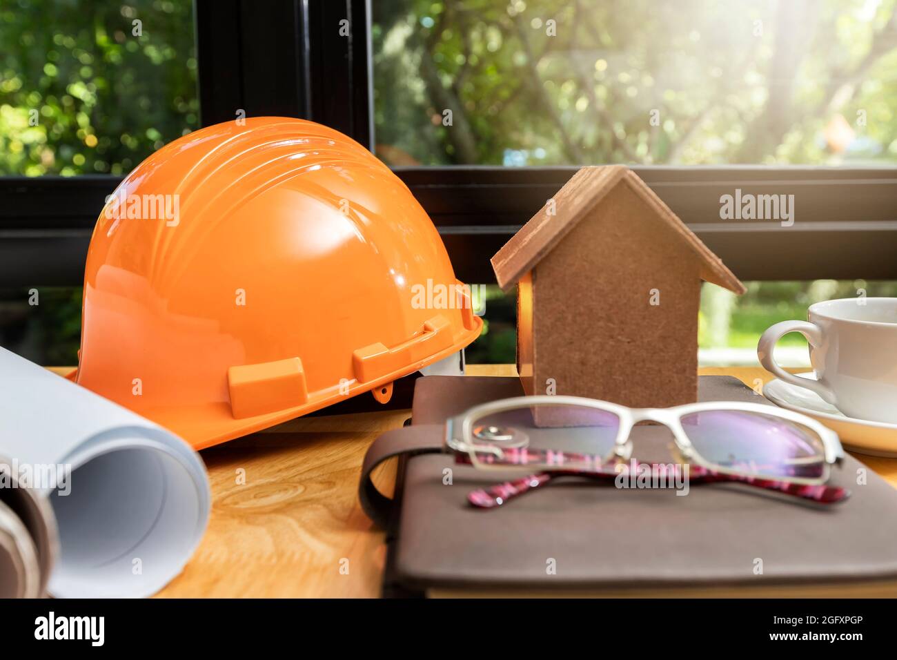 Architectural concept. Architects house model with blueprint and helmet