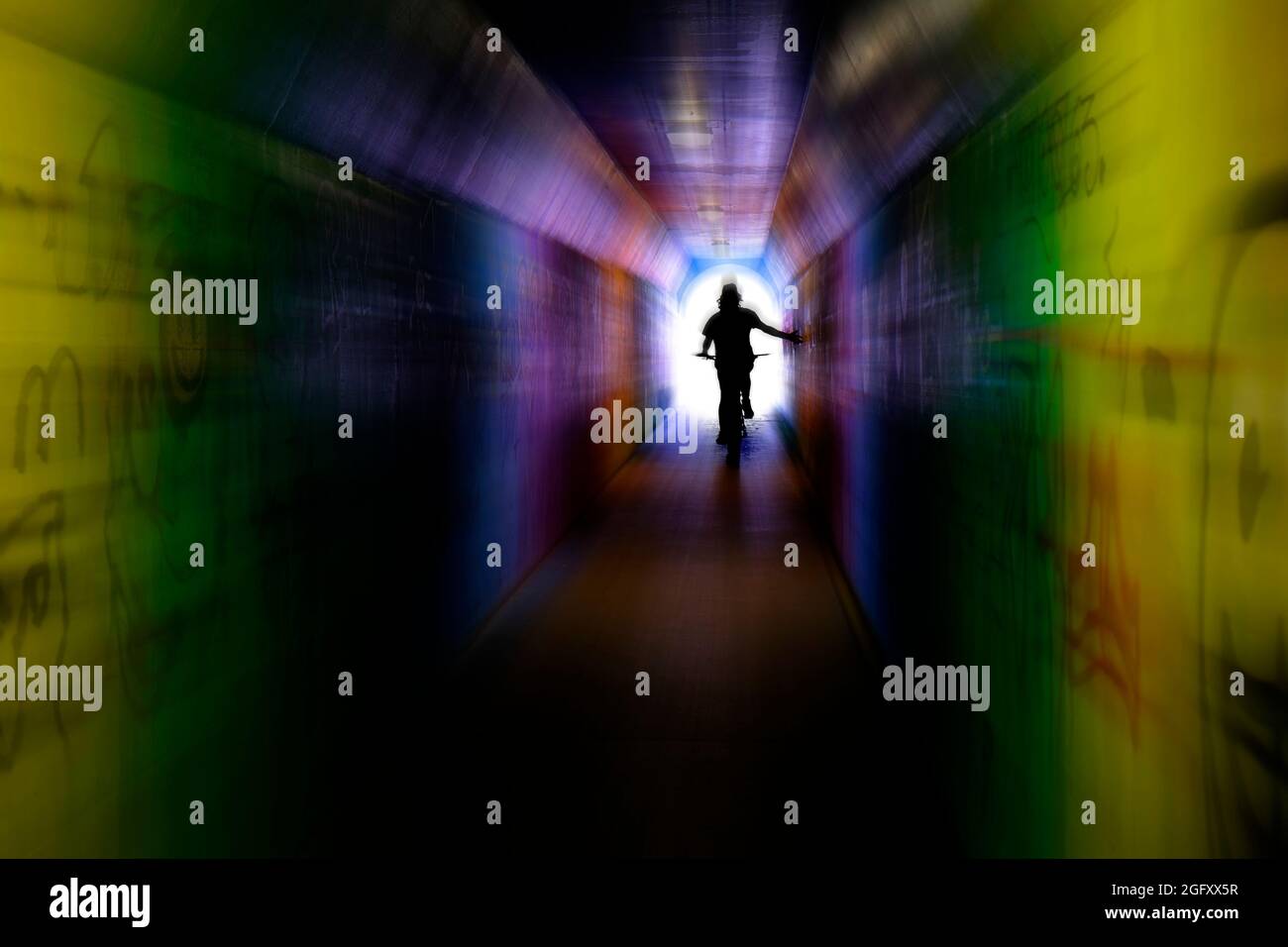 Riding bike bicycle through tunnel with graffiti innercity zoom effect motion Stock Photo