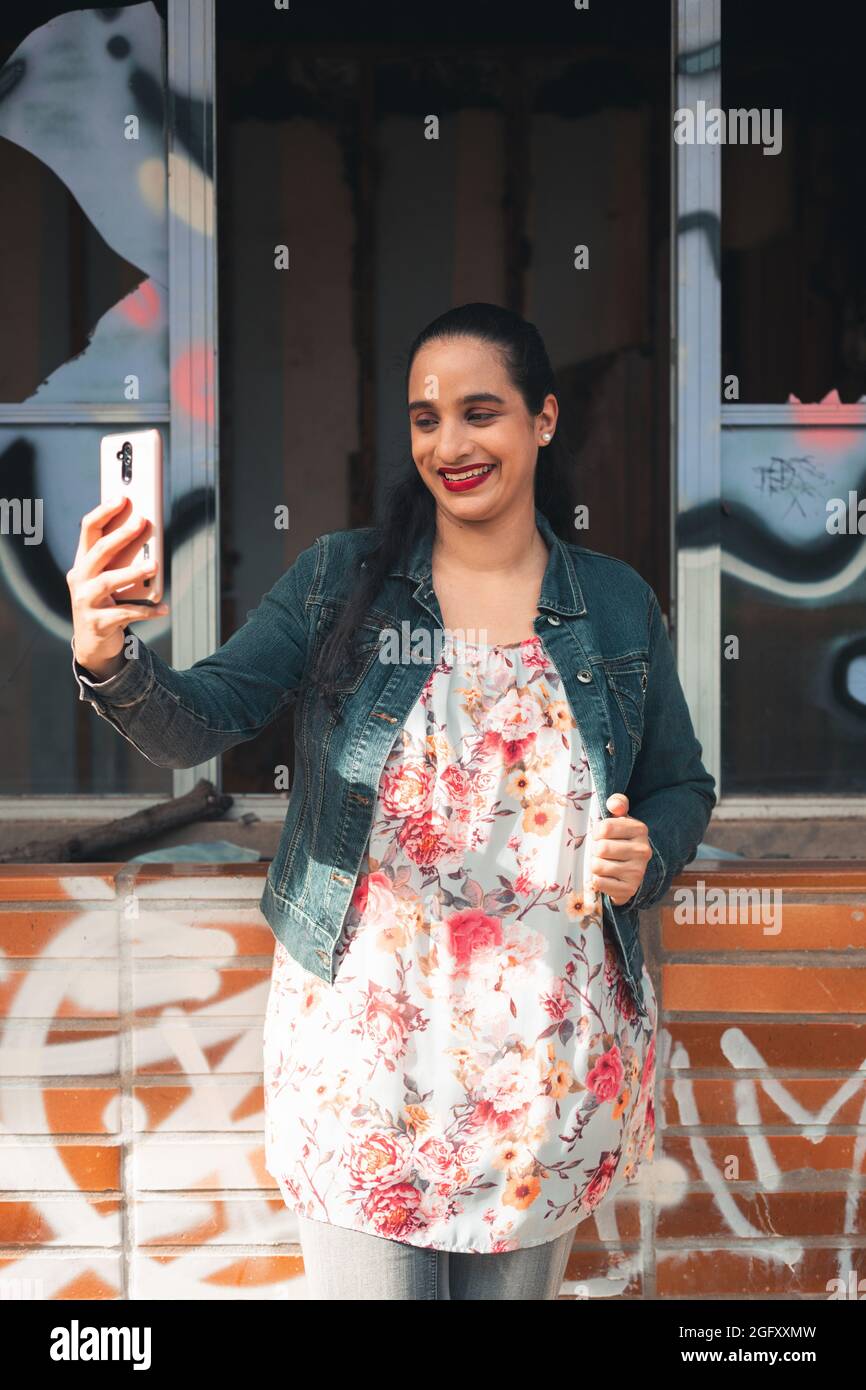 Vertical shot of a Latin woman smiling for a photo Stock Photo - Alamy