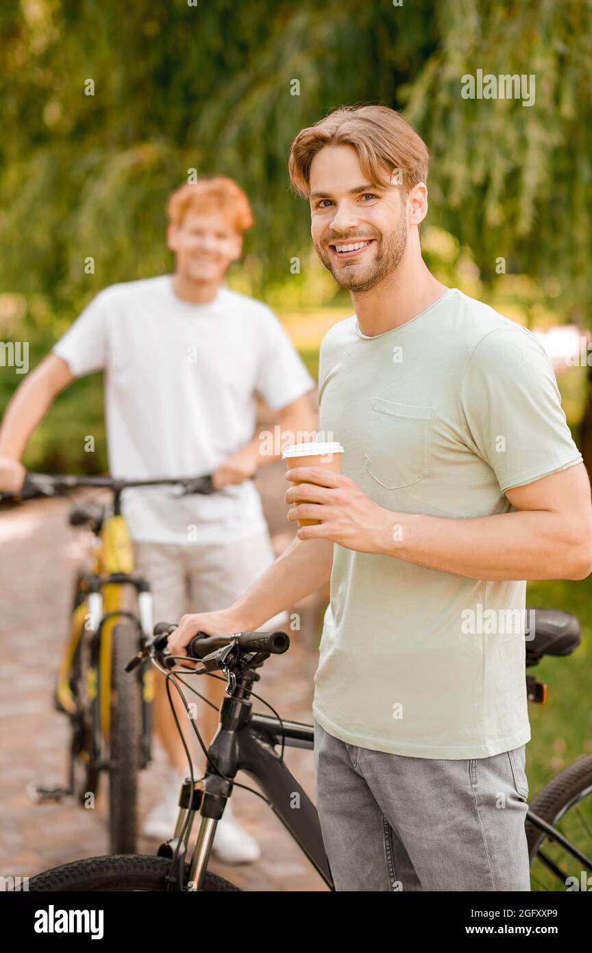 Two bicycle riders enjoying their coffee break together Stock Photo - Alamy