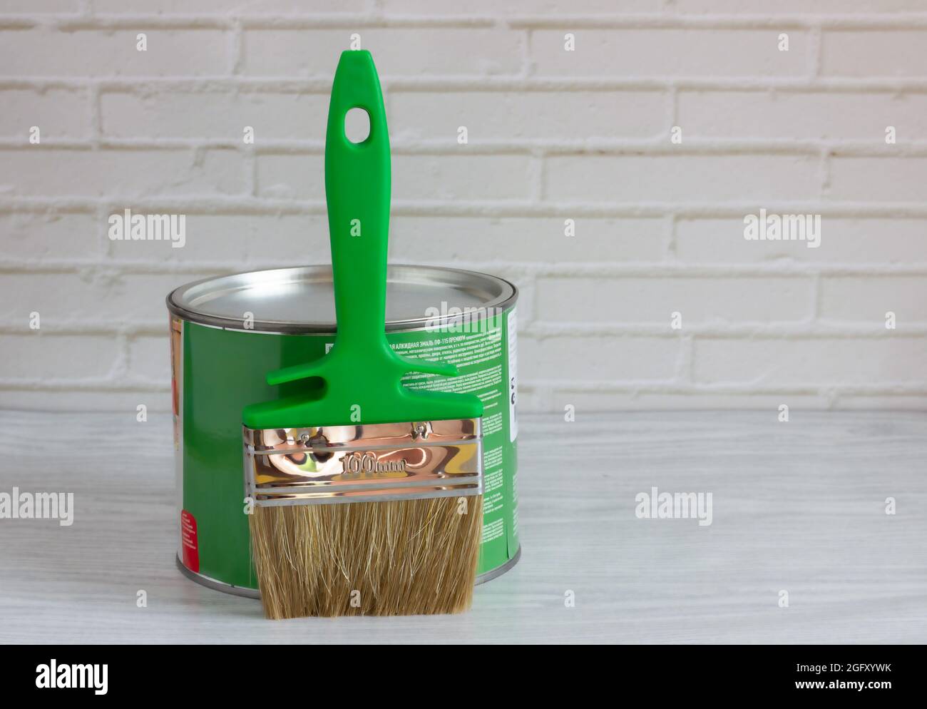 brush with green paint on a light background. renovation concept Stock Photo