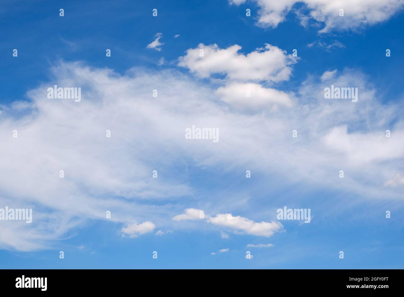 fluffy white clouds on a deep blue sky in summer Stock Photo