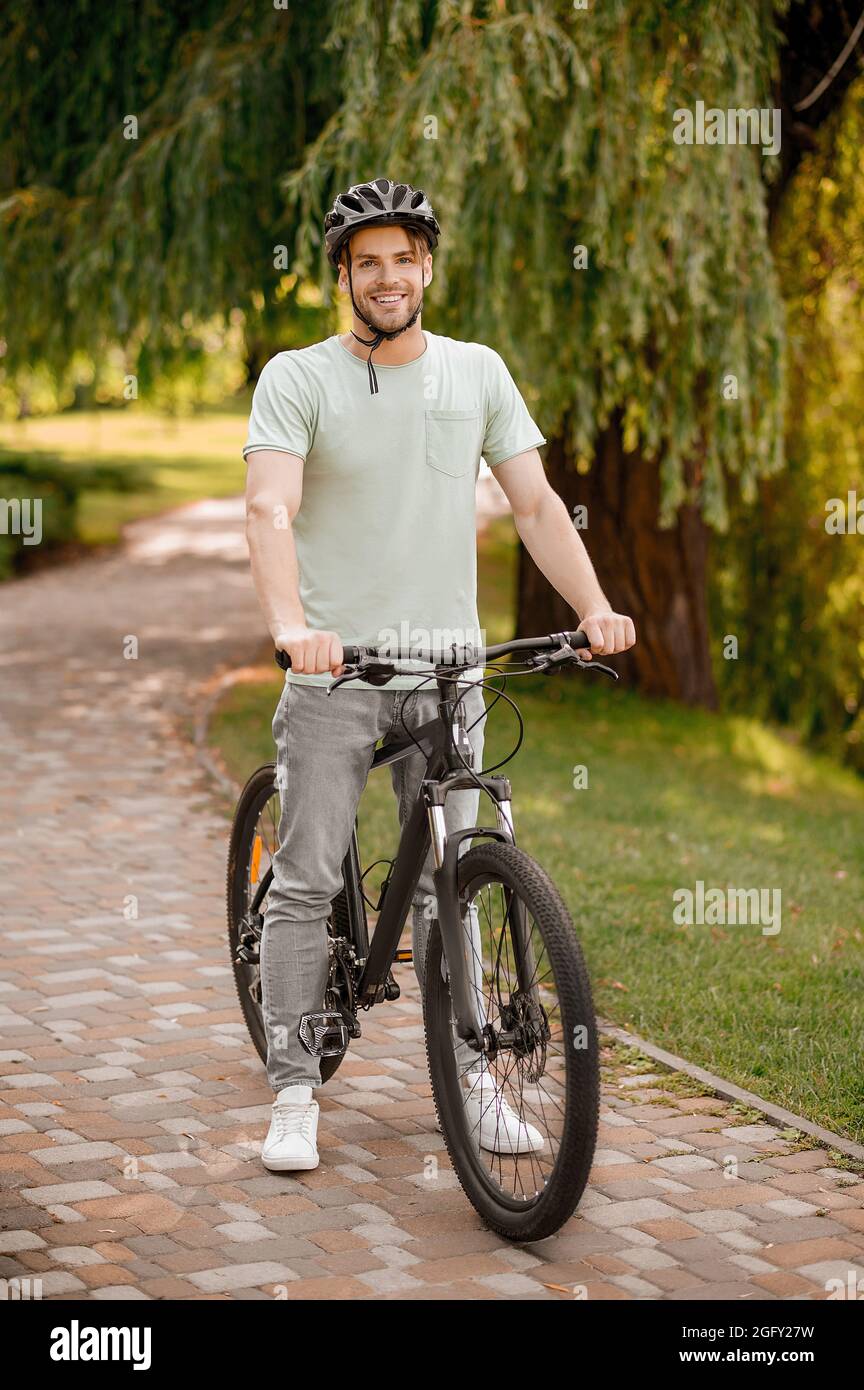 Smiling attractive cyclist in a local park Stock Photo