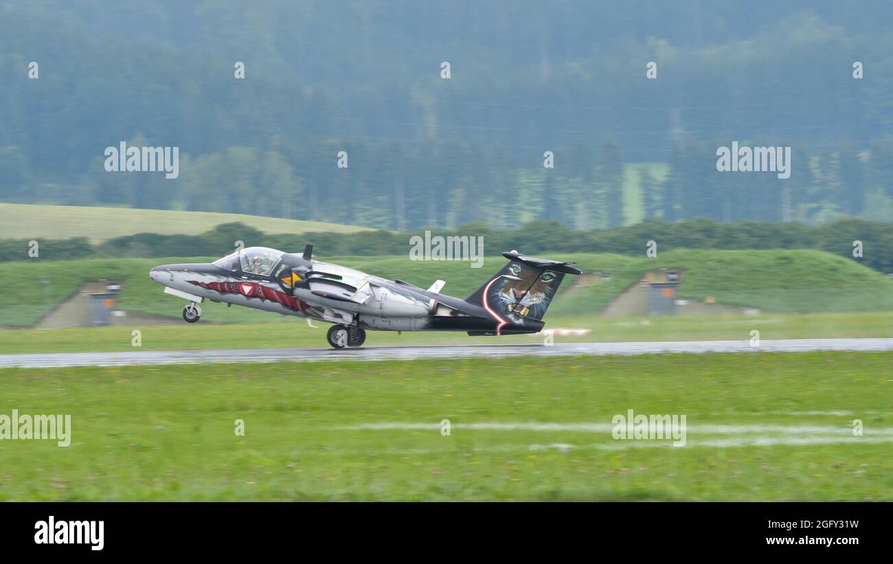 Zeltweg, Austria SEPTEMBER, 6, 2019 Military plane with cat livery lands at an alpine airport in a green valley. SAAB 105 of Austrian Air Force Stock Photo