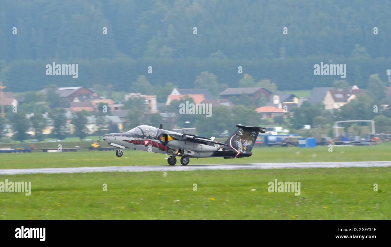 Zeltweg, Austria SEPTEMBER, 6, 2019 Special colors military airplane landing under the rain. SAAB 105 of Austrian Air Force Stock Photo
