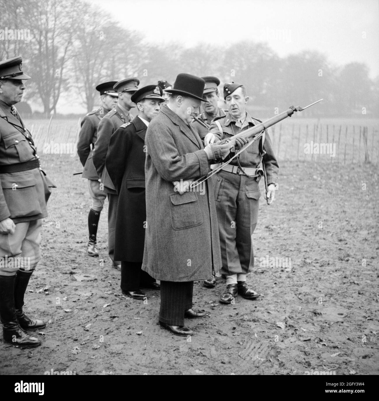 Winston Churchill inspecting the new Lee-Enfield No. 4 rifle with spike bayonet during a visit to 53rd Division in Kent, 20 November 1942. Stock Photo