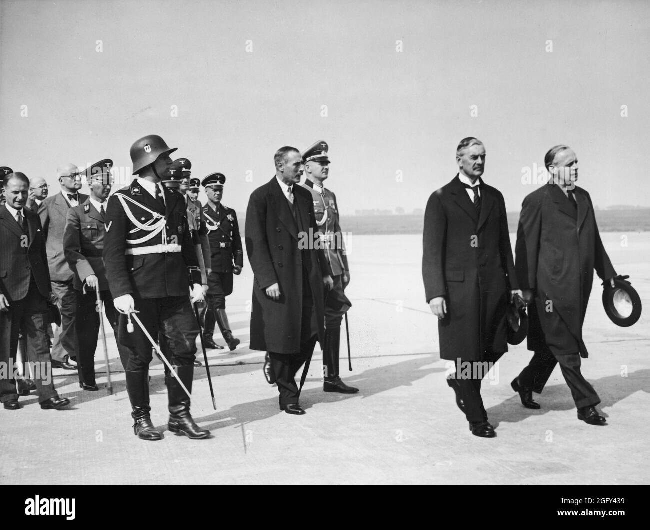 British Prime Minister Neville Chamberlain at the Munich airfield Oberwiesenfeld on September 29th. 1938. Neville Henderson is walking with Joachim von Ribbentrop (Minister of Foreign Affairs of Nazi Germany) Stock Photo