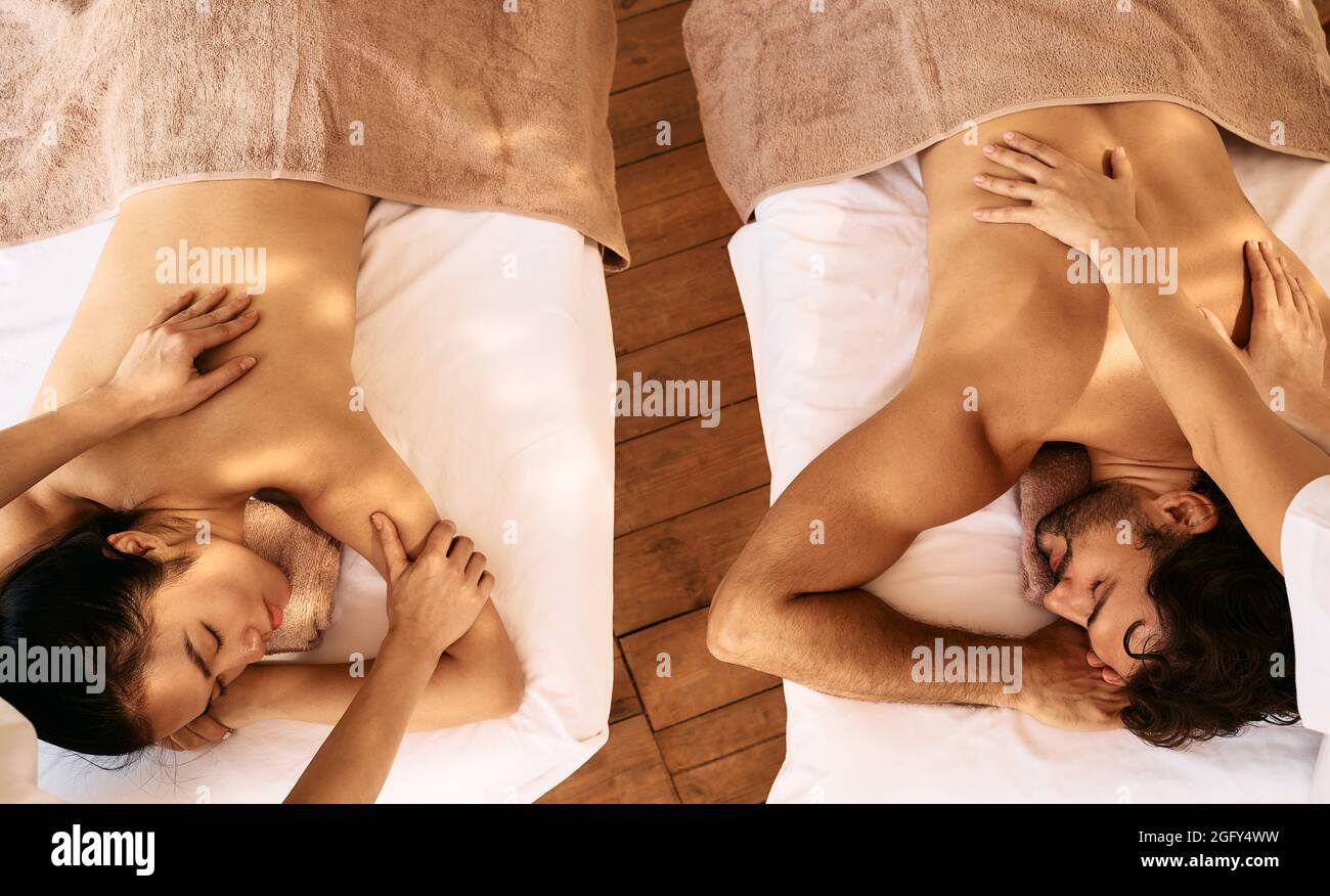 Couple massage with aroma oil, top view. Beautiful couple spend time together and enjoying romance massage, spa resort Stock Photo