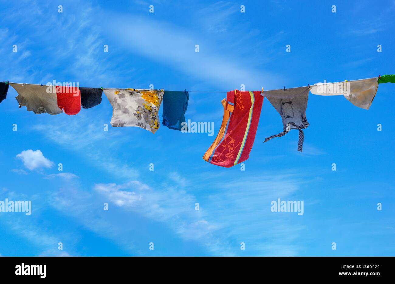 Laundry on a washing line on a windy day. Stock Photo