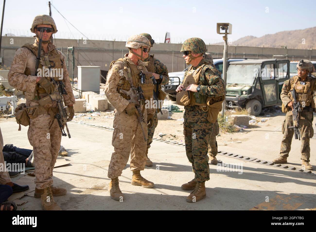 U.S. Marine Brig. Gen. Farrell J. Sullivan, the commander of the Naval Amphibious Task Force 51/5th Marine Expeditionary Brigade, speaks to LtCol. Brad Whited, commanding officer of 2nd Battalion, 1st Marine Regiment during an evacuation at Hamid Karzai International Airport, Kabul, Afghanistan, Aug. 24. U.S. service members and coalition forces are assisting the Department of State with a non-combatant evacuation operation (NEO) in Afghanistan. (U.S. Marine Corps photo by Staff Sgt. Victor Mancilla) Stock Photo