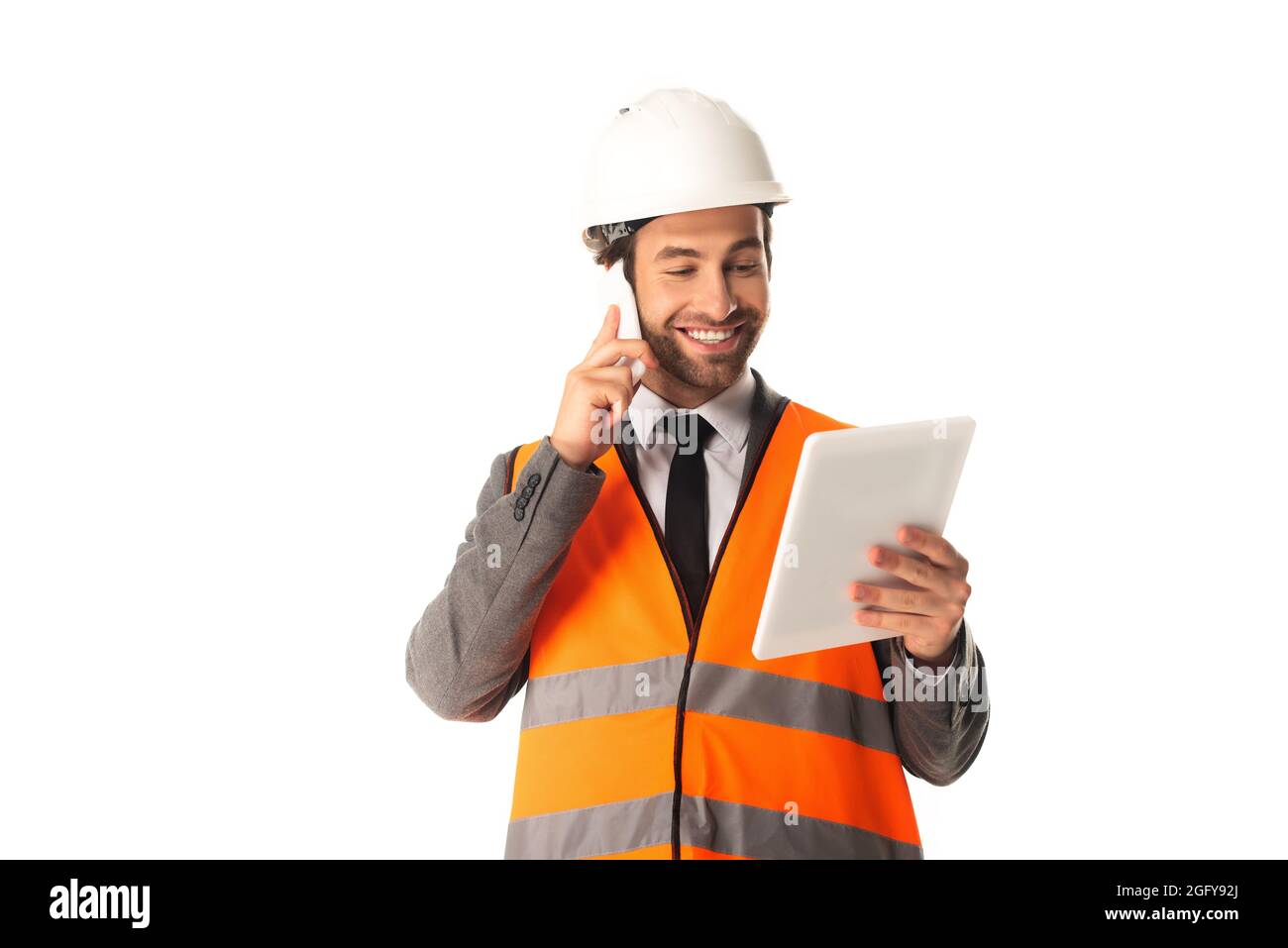 Engineer talking on cellphone and holding digital tablet isolated on white Stock Photo