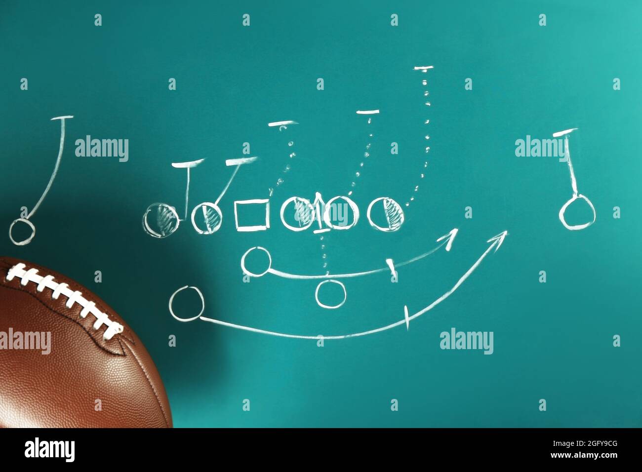 Scheme of American football game and ball on blackboard background