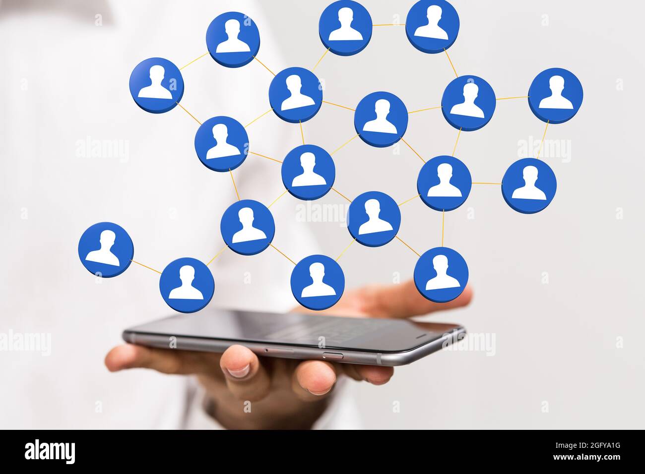 Person's hand holding a phone with 3D rendered people silhouettes in ...