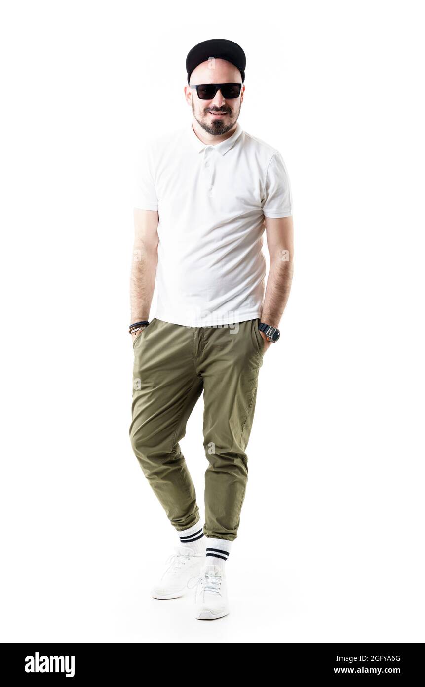 Happy comfortable stylish young man wearing chino pants cap and