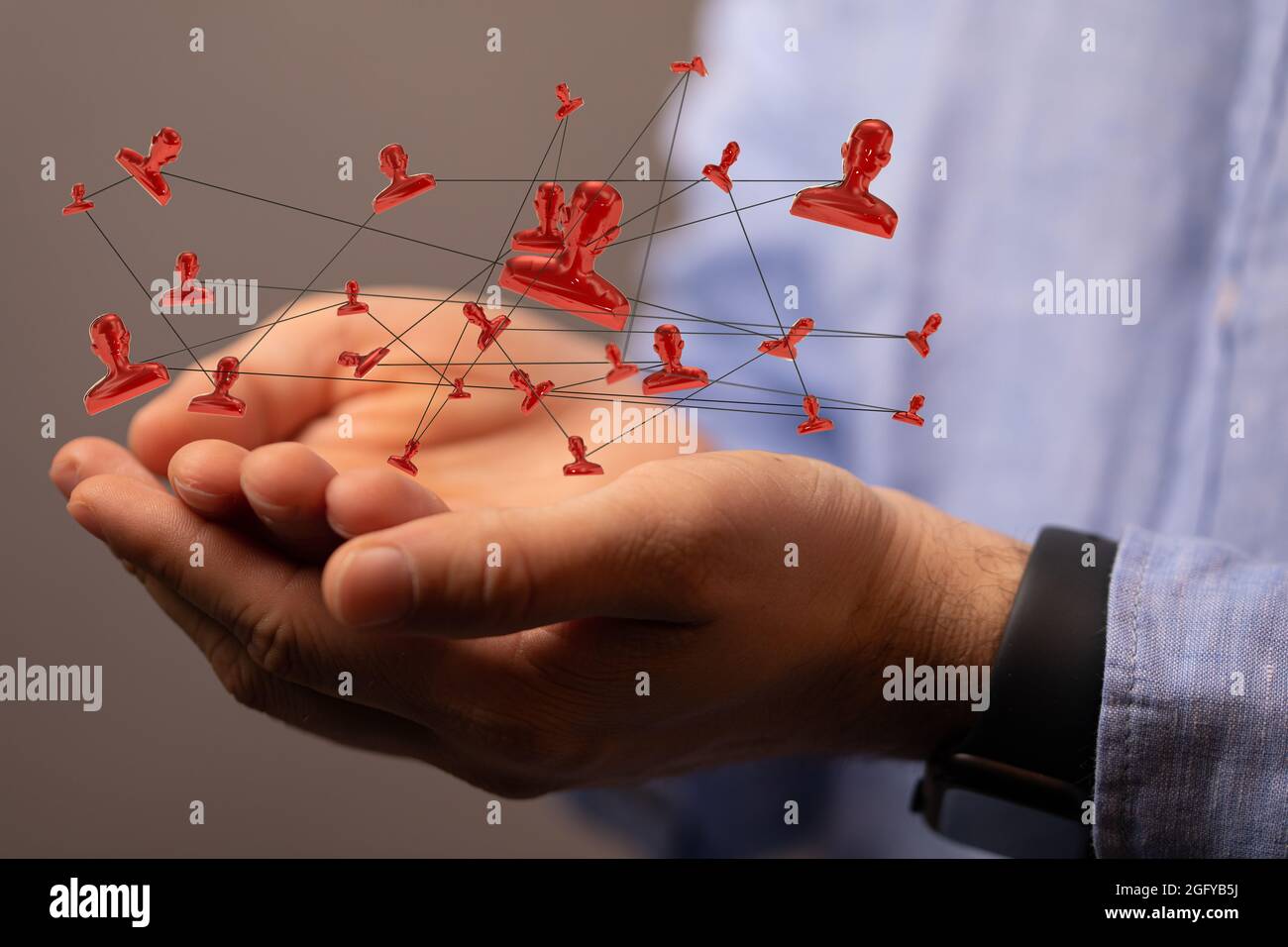 3D rendered people silhouettes held in a person's hand Stock Photo - Alamy