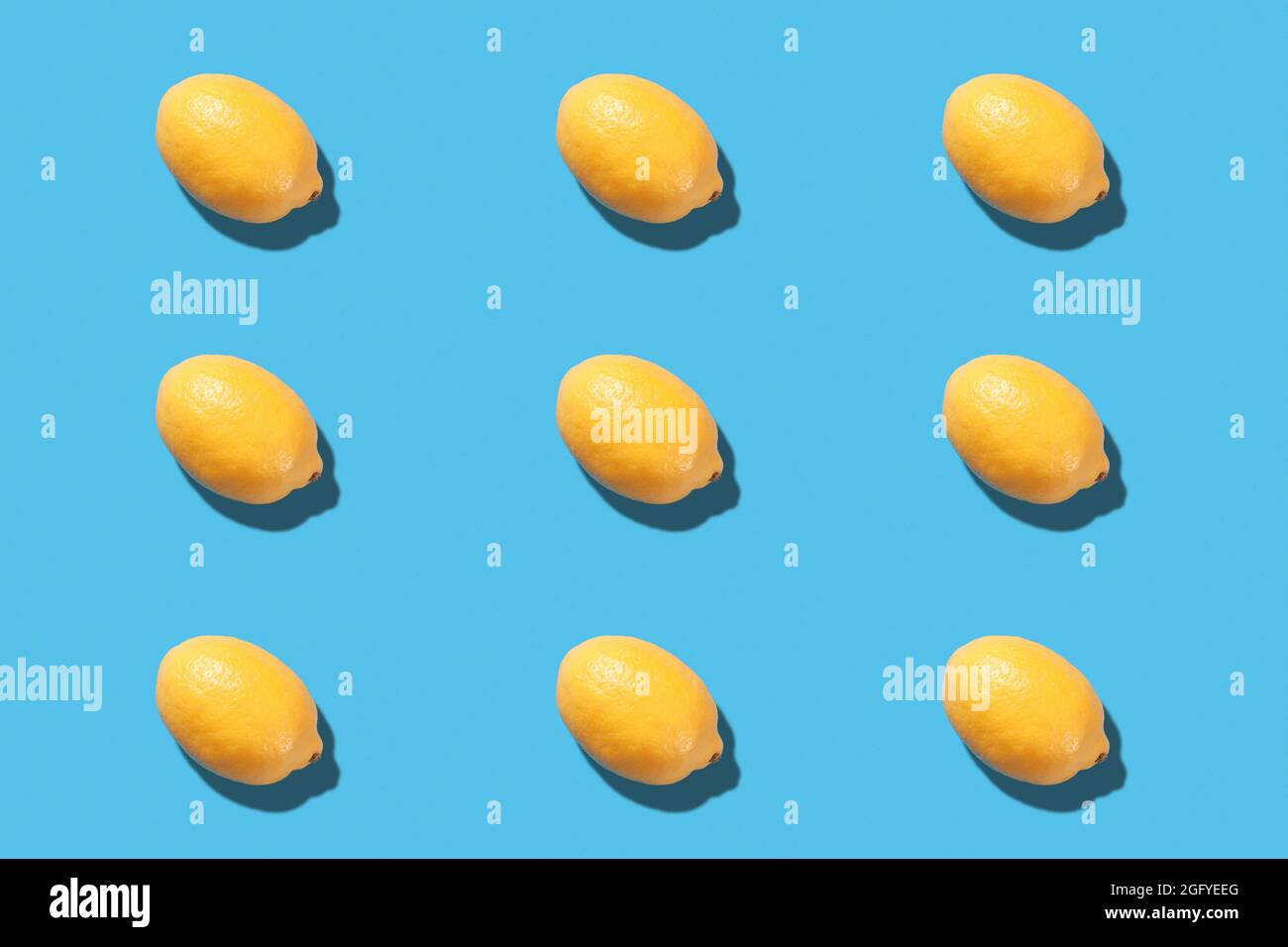 Fresh lemon lies on a blue background. Lemon pattern Stock Photo