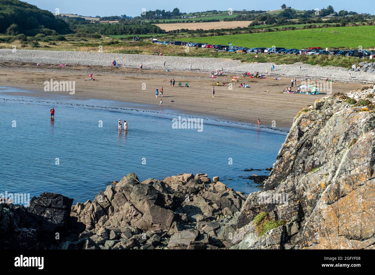 Kilmurrin Cove, County Waterford, Ireland. 27th Aug, 2021. The sun shone gloriously on Kilmurrin Cove on the Copper Coast in County Waterford with many tourists taking advantage of the good weather. Met Éireann has forecast the sunshine will continue over the weekend. Credit: AG News/Alamy Live News Stock Photo