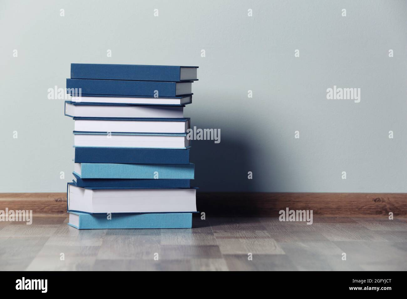 Stack of books on floor indoors Stock Photo Alamy