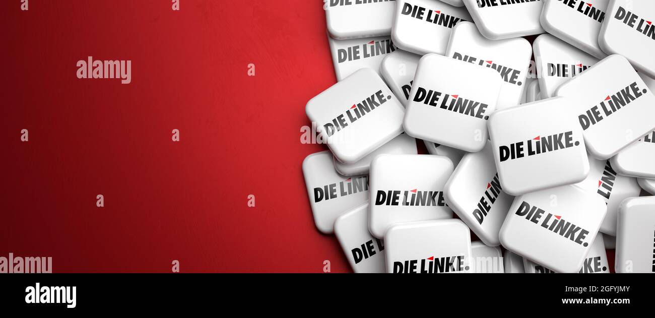 Logos of the leftist German political party 'Die Linke' on a heap on a table. Copy space. Web banner format. Stock Photo