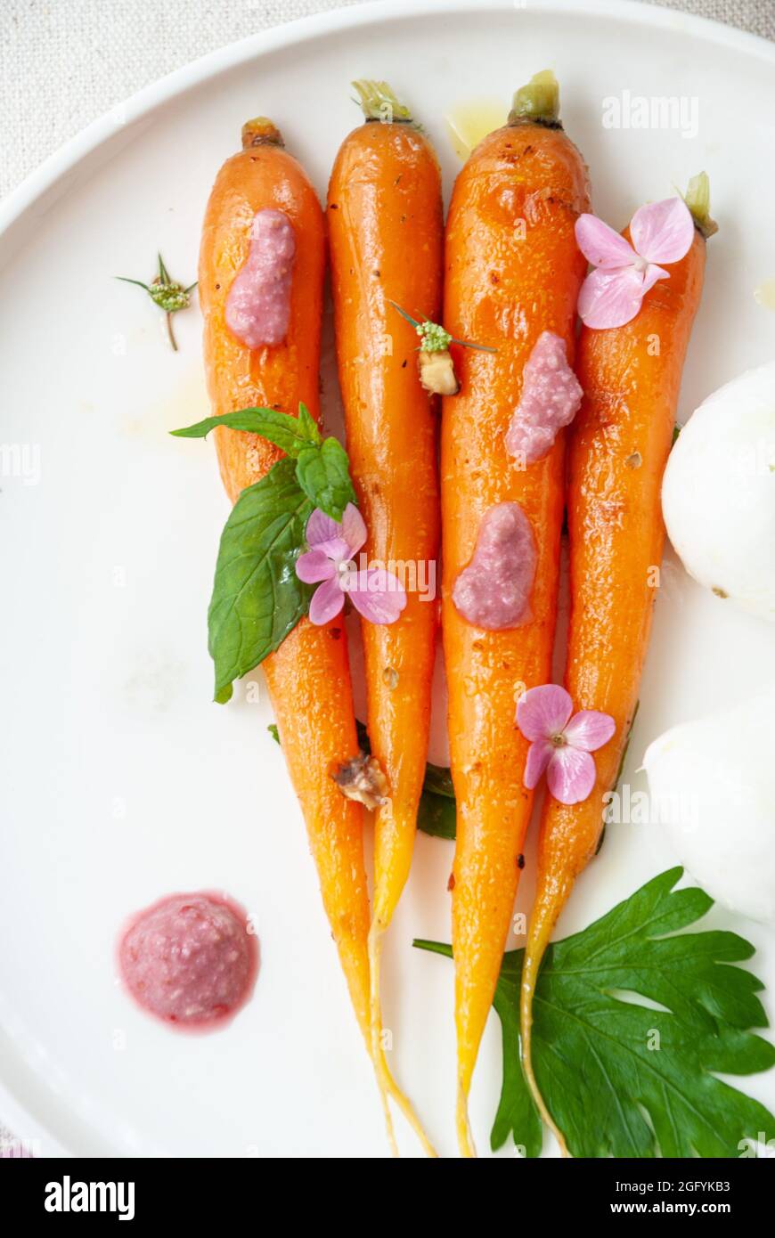 Grilled carrot with raspberry sauce and olive oil Stock Photo