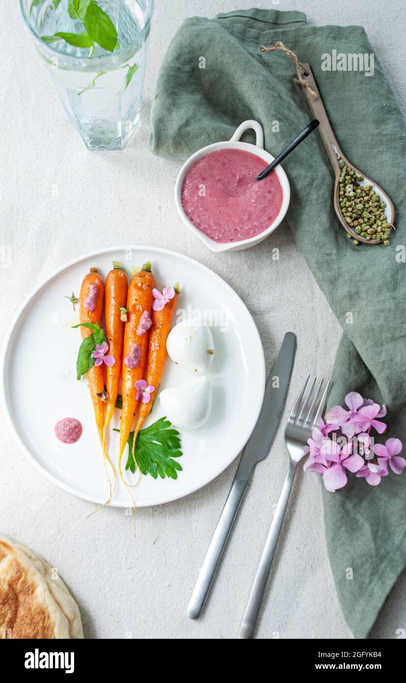 Grilled carrot with raspberry sauce and olive oil Stock Photo