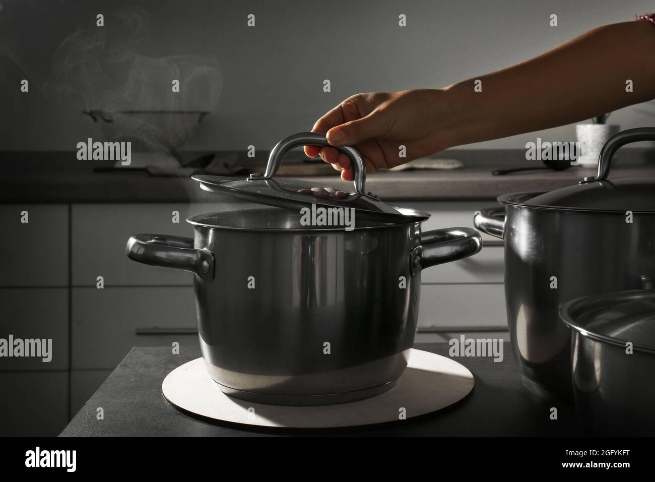 Preparing food in metal pan in kitchen Stock Photo Alamy