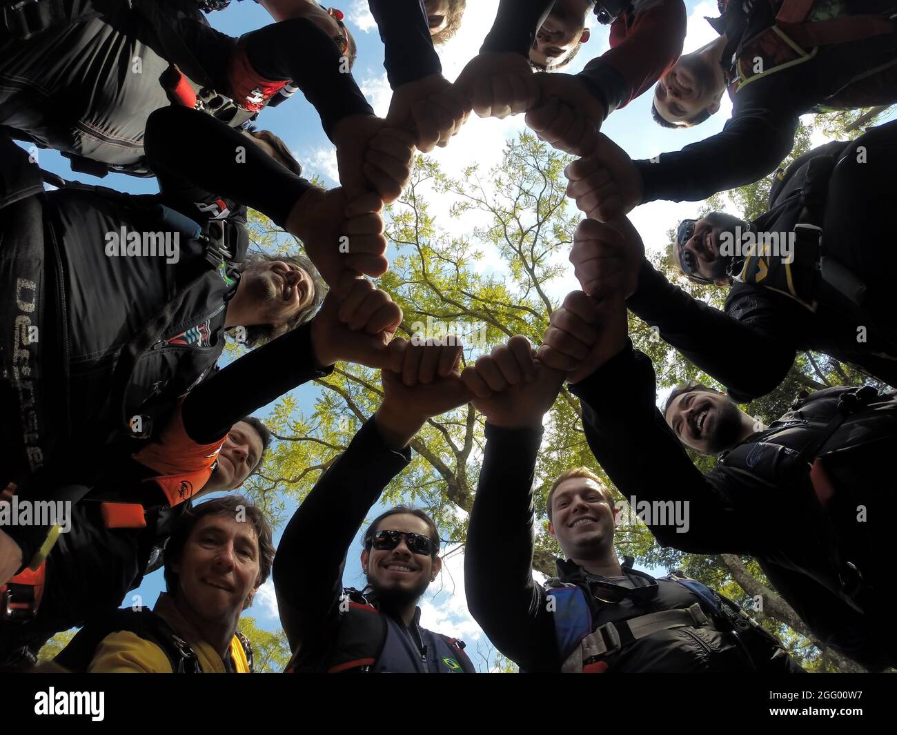 Skydiving people hands as symbol of their partnership and strong teamwork. Stock Photo