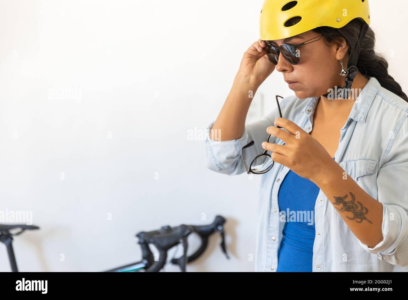 Woman putting on a helmet hi-res stock photography and images - Alamy