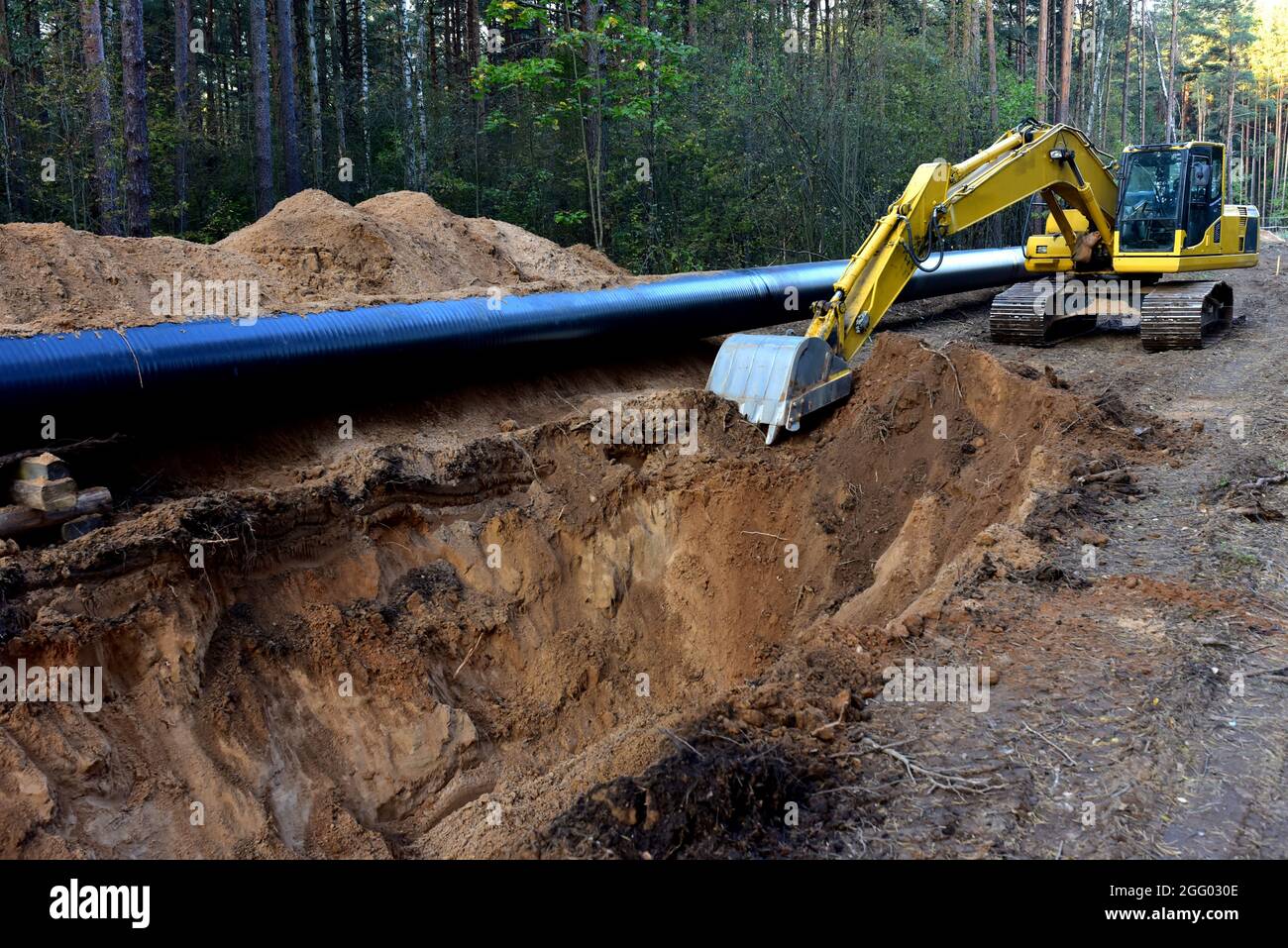 Excavator during earthwork for laying Crude oil and Natural gas 