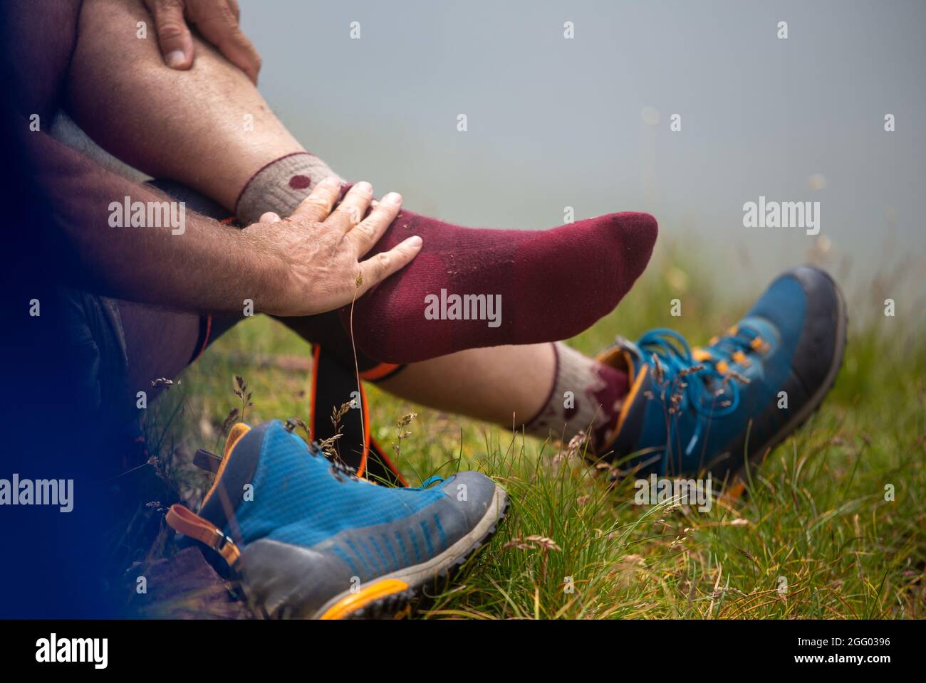 Close up of hiker's feet in socks without shoes resting on mountain peak Stock Photo