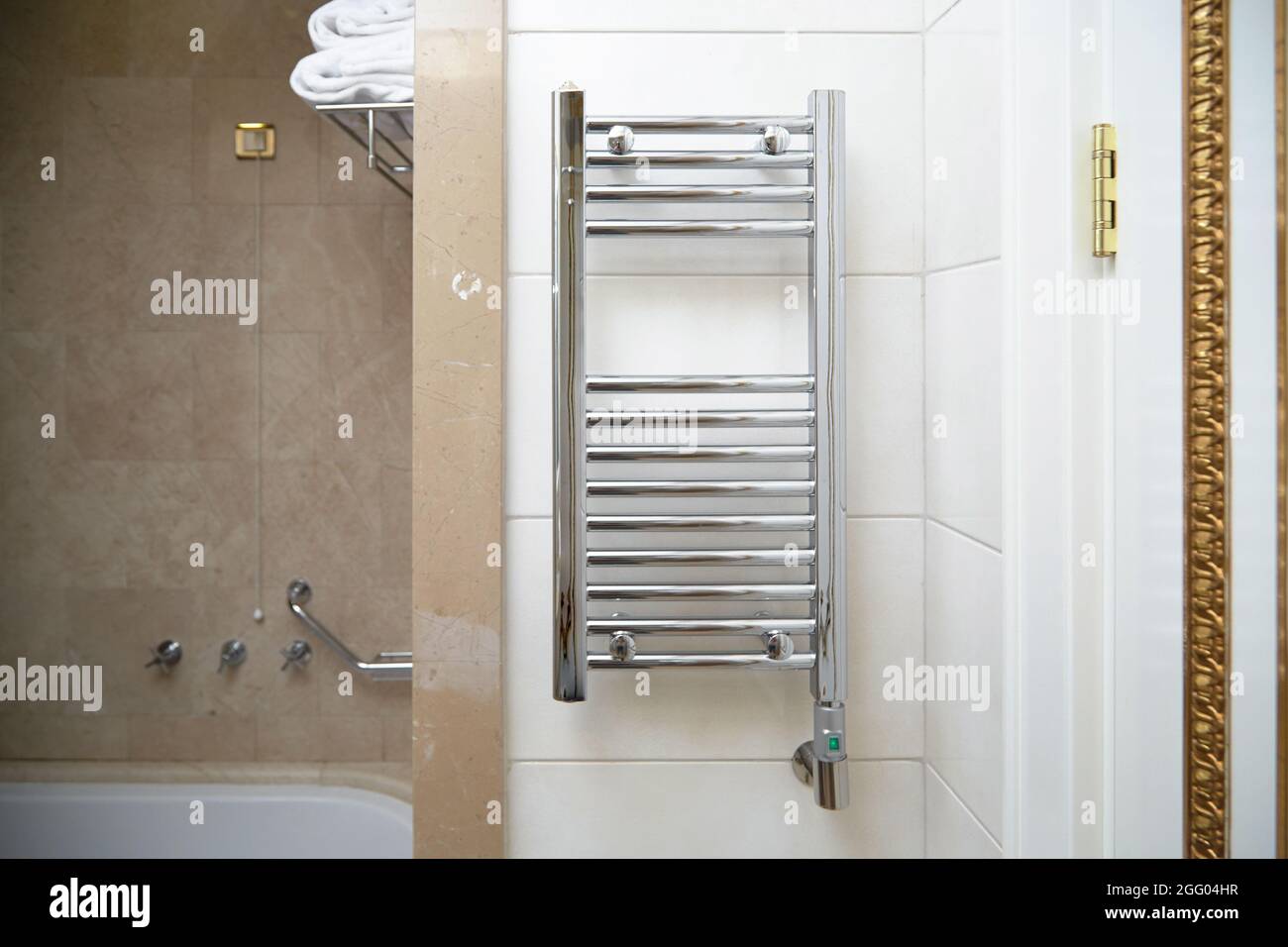 towel dryer, bathroom heater with chrome coating on the wall in the