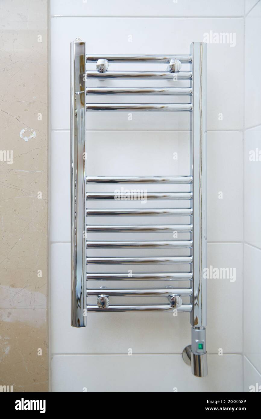 towel dryer, bathroom heater with chrome coating on the wall in the