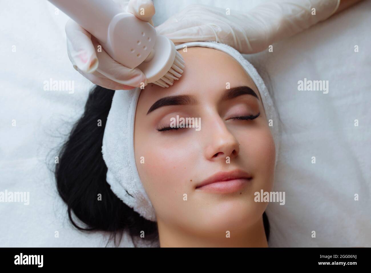 Facial massage. Care skin brushing spa procedure and cosmetology Stock Photo