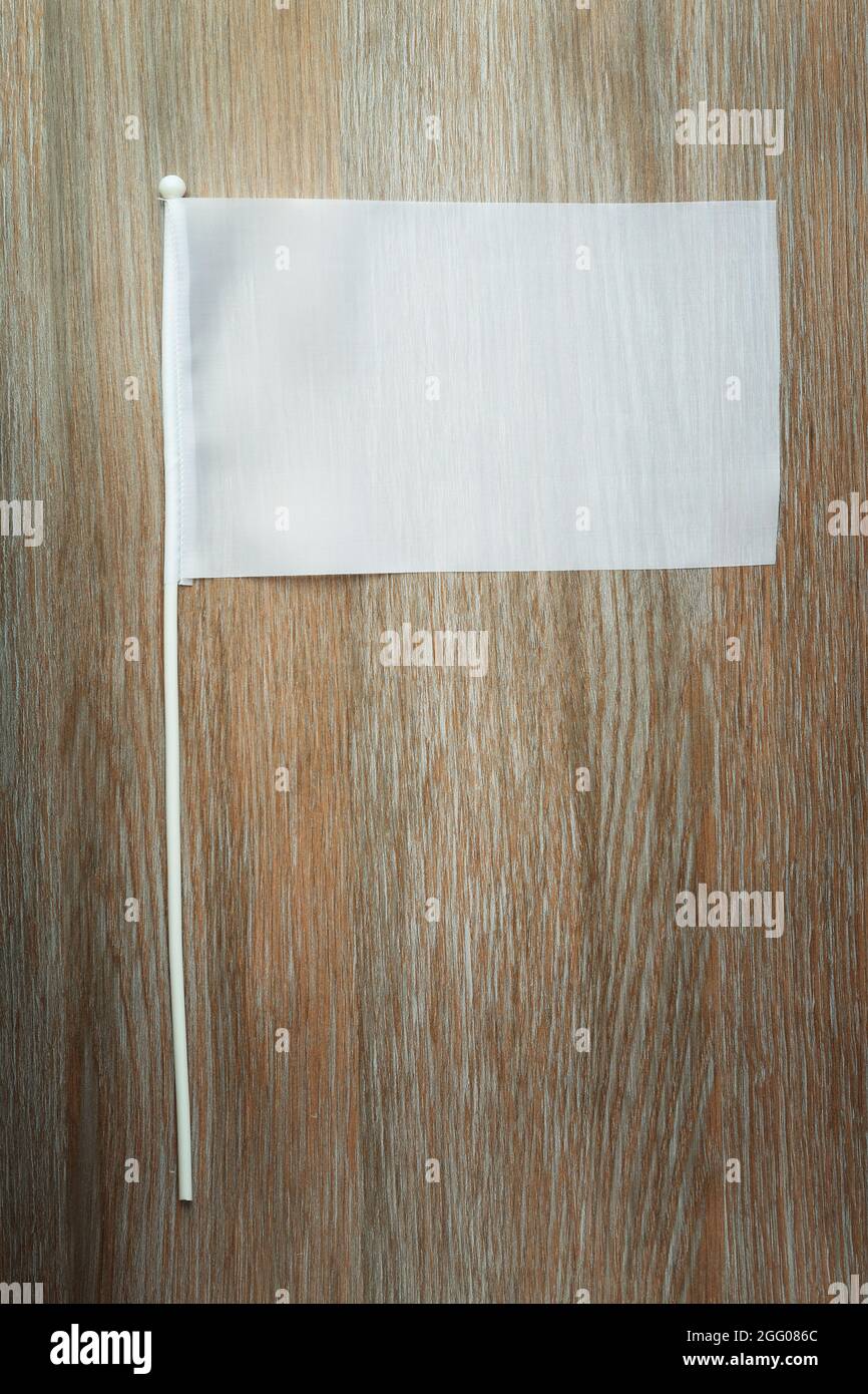 Blank white flag on wooden background Stock Photo Alamy