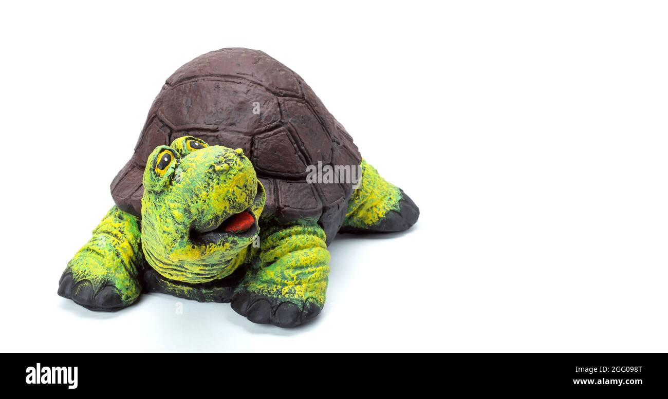 Concrete tortoise garden figure painted with colored paints, landscape object in the form of a cheerful turtle with a brown shell and a green head iso Stock Photo