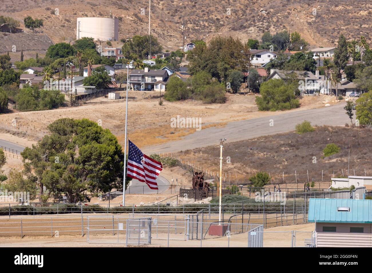 The American flag flies at half-mast in the home town of Marine Corps Lance Corporal Kareem Nikoui in Norco, California, U.S. August 27, 2021. Nikoui was killed in action while stationed at the Hamid Karzai International Airport in Kabul, Afghanistan.     REUTERS/Mike Blake Stock Photo