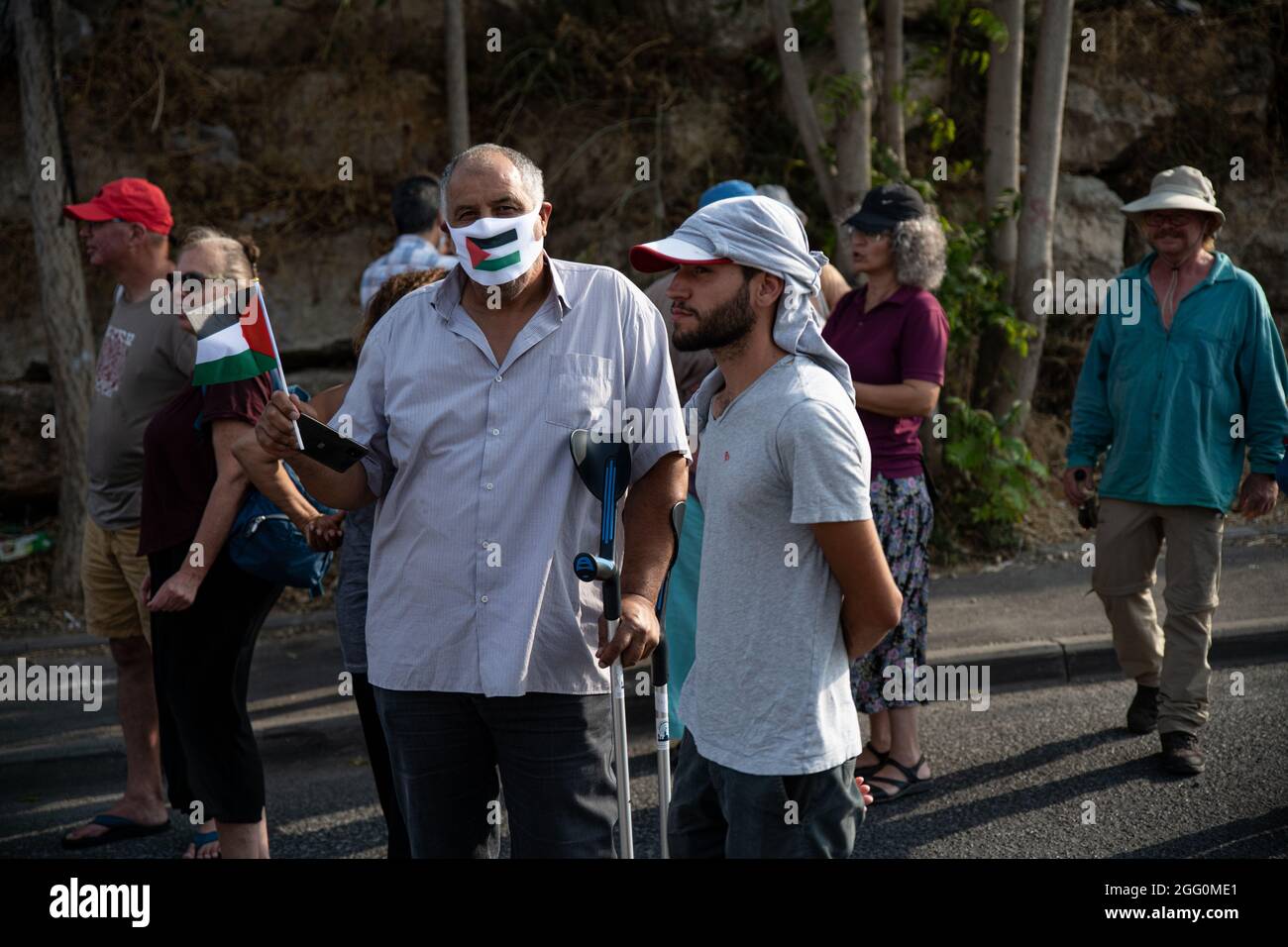 Jewish and Palestinian protestors in Sheikh Jarach during the weekly protest in front of the Israeli Police checkpoint at the entrance to the neigberhood - which is monitoring entrance of non-residents since last April. Sheikh Jarach. Jerusalem, Israel. 28th Aug 2021. (Photo by Matan Golan/Alamy Live News) Stock Photo