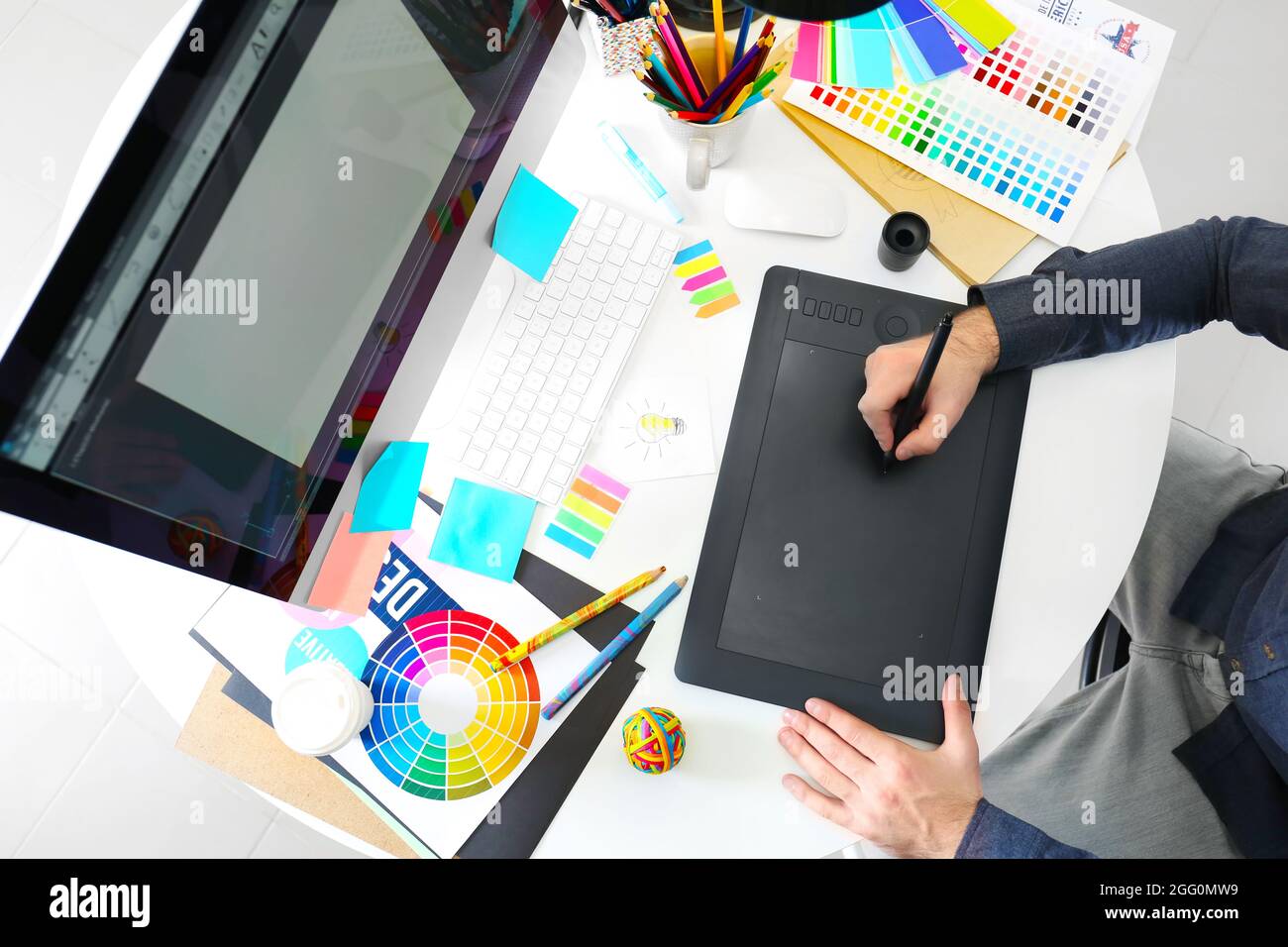 Designer Using Tablet Modern designer working with graphic tablet Stock Photo - Alamy