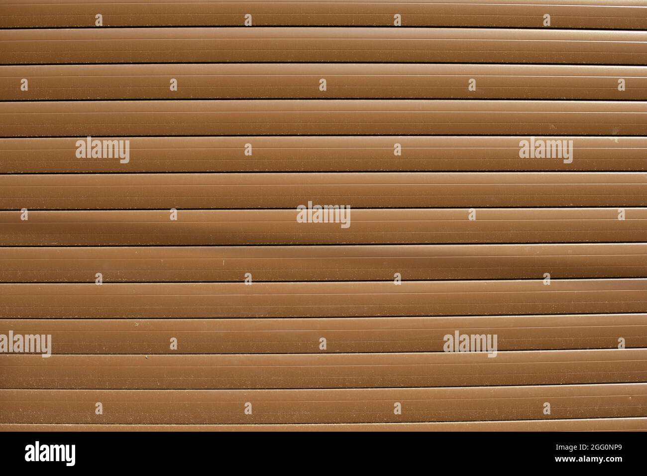 Brown blinds on the street. The texture of the plastic reflective surface. Straight lines in industrial material. Stock Photo